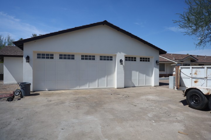 A well-designed garage addition matches nicely with the original ranch-style home.