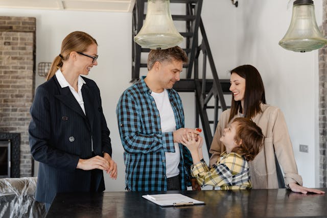 Real estate agent with family in their new house.